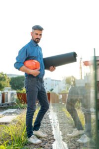 full-shot-architect-holding-blueprints