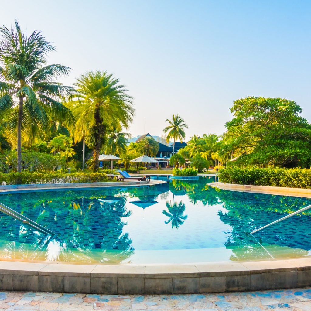 Outdoor swimming pool Umbrella and chair around beautiful luxury outdoor swimming pool in hotel resort - Boost up color Processing